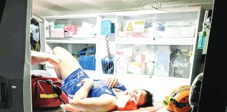 Jonas Tibayan is seen in the ambulance that brought him to the hospital. MPBL PHOTO
