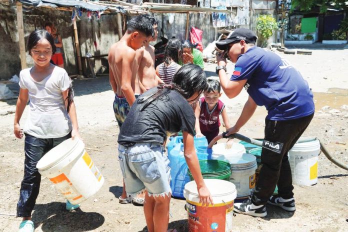 As Iloilo continues to grow, the need for affordable, reliable water has never been more urgent. Photo shows Iloilo City residents receiving free cold water for washing and bathing from a private company in April 2024.