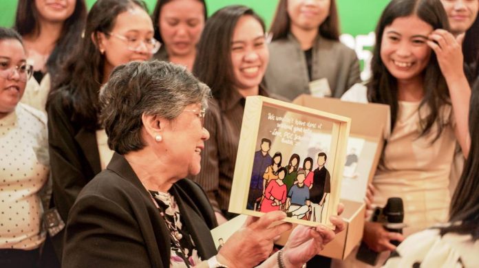 Palawan Group Co-founder and Deputy Chairman, Angelita M. Castro, smiles warmly at the graduates as they handed a token and appreciation to the Castro family
