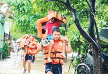 Disaster Response Group (DRG) Team 1 of Coast Guard District Southern and Northern Negros rescued several families in Barangay Banago, Bacolod City on September 26. PHOTO COURTESY OF RMN DYHB BACOLOD