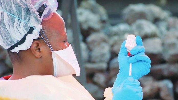 Congo_resized A nurse in protective gear prepares a vaccine against Ebola in Congo. AFP