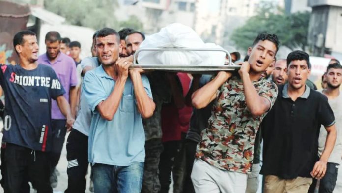 Gaza Male mourners carry a body during the funeral for Palestinians killed in strikes, according to medics, at Al-Shifa Hospital in Gaza City. REUTERS