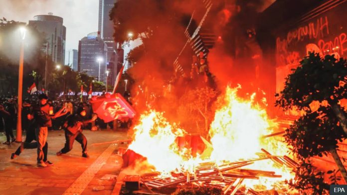 Demonstrators burned road barriers outside the Jakarta police headquarters. EPA