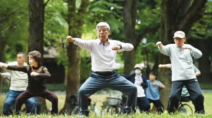 Elderly Japanese perform health physical exercise in a park. People in Japan tend to have healthier diets, lower prevalence of common diseases, and a culture of group exercise. GETTY IMAGES