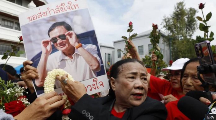 Supporters of Thaksin wearing his party's trademark red colour showed up at the court on Tuesday. EPA