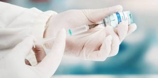 A health practitioner transfers the Covid-19 vaccine from a vial to the syringe. The Advisory Committee on Immunization Practices makes recommendations on the use of vaccinations in the United States. GETTY IMAGES