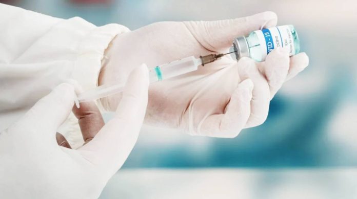 A health practitioner transfers the Covid-19 vaccine from a vial to the syringe. The Advisory Committee on Immunization Practices makes recommendations on the use of vaccinations in the United States. GETTY IMAGES