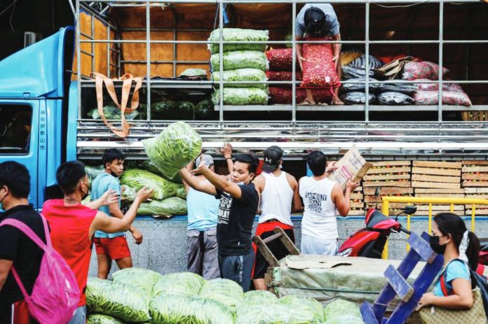 consignees for hire copy Workers transport fresh drops of vegetables in Divisoria market in Manila in this file photo. GEORGE CALVELO, ABS-CBN NEWS/FILE PHOTO