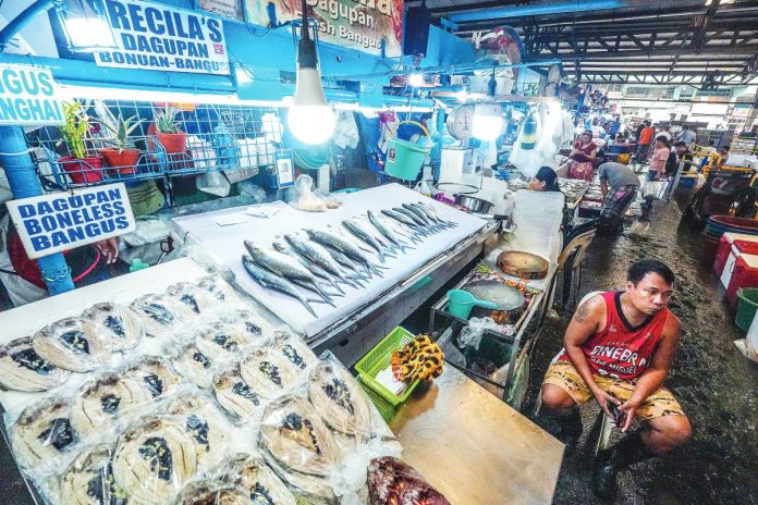 FRESH CATCH A vendor waits for customers at his milkfish (bangus) stall in Farmers Market, Quezon City. An economist projected inflation to settle at 2.1 percent in September 2025, higher than the 1.5 percent in August but still within the central bank's target. PNA PHOTO BY ROBERT OSWALD P. ALFILER