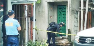 A member of the Explosive Ordnance Disposal (EOD) team of the Iloilo City Police Office inspects an unattended parcel outside a residence in Barangay San Vicente, Jaro, Iloilo City, on September 9, as police secure the perimeter following a bomb scare. AJ PALCULLO/PN