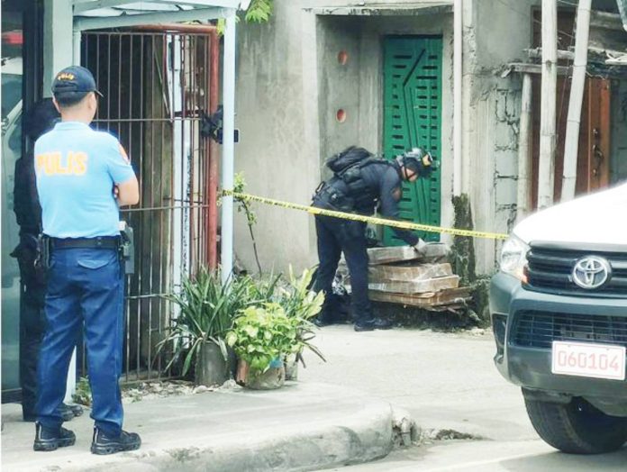 mai ICPO1 copy A member of the Explosive Ordnance Disposal (EOD) team of the Iloilo City Police Office inspects an unattended parcel outside a residence in Barangay San Vicente, Jaro, Iloilo City, on September 9, as police secure the perimeter following a bomb scare. AJ PALCULLO/PN