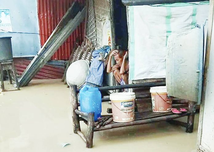 Knee-level floodwaters swamp a household in Barangay Sto. Domingo, Arevalo, Iloilo City, as southwest monsoon rains enhanced by Super Typhoon Nando continue to drench Western Visayas.