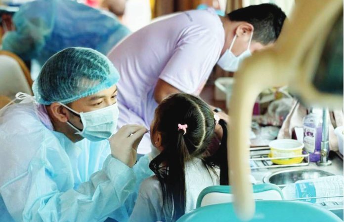 neljoy concepcion (1) copy Healthcare workers provide free dental and immunization services to children during the Family Health and Nutrition Fair in Concepcion, Iloilo, which served over 300 residents. ILOILO PROVINCIAL HEALTH OFFICE PHOTO