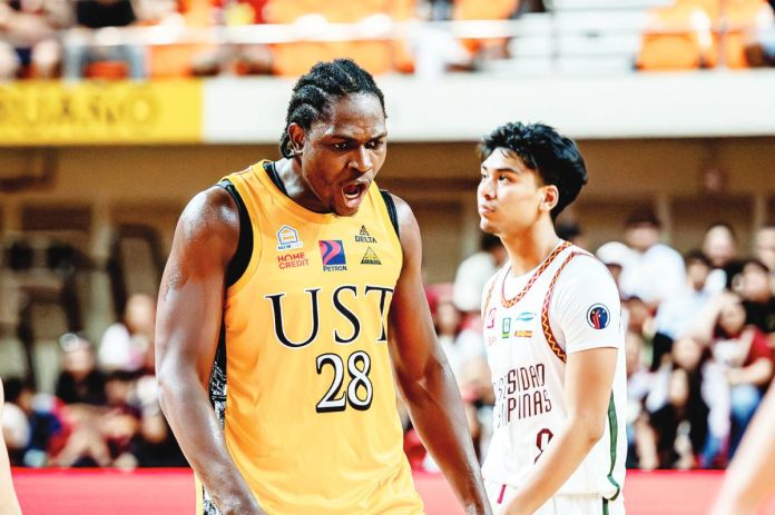 Rookie Collins Akowe powers University of Santo Tomas Growling Tigers to season opener win over University of the Philippines Fighting Maroons. UAAP PHOTO