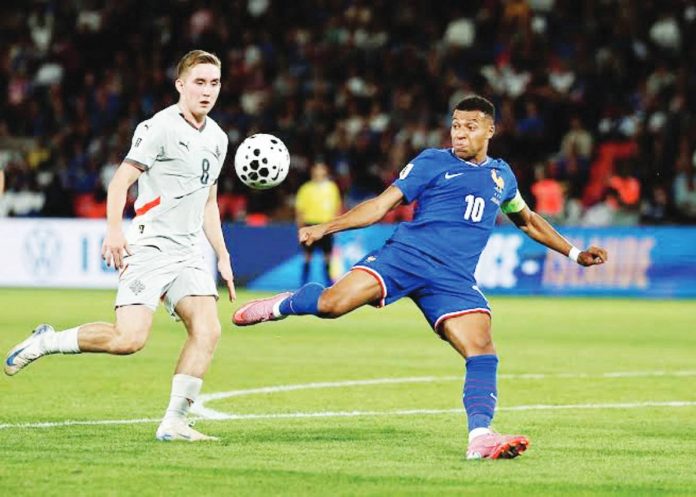 France's Kylian Mbappe in action with Iceland's Isak Johannesson. REUTERS