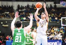University of Santo Tomas Growling Tigers’ Nicael Cabañero scores against the defense of De La Salle University Green Archers' Mason Amos. UAAP PHOTO