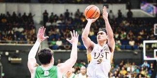 University of Santo Tomas Growling Tigers’ Nicael Cabañero scores against the defense of De La Salle University Green Archers' Mason Amos. UAAP PHOTO