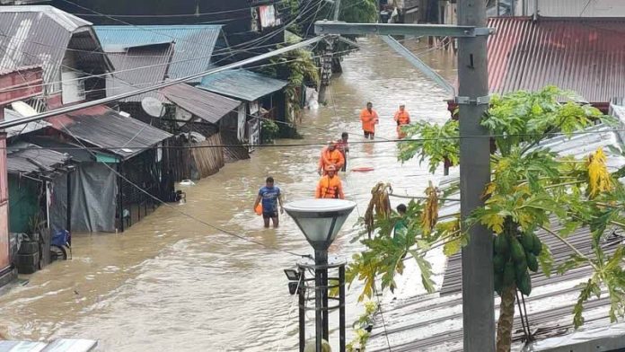 Aklan flood_compressed Personnel from the Buruanga Municipal Disaster Risk Reduction and Management Office monitor rainfall and river levels on October 27 as they stay on alert for possible renewed flooding following continuous rains in Aklan Province. MDRRMO BURUANGA PHOTO
