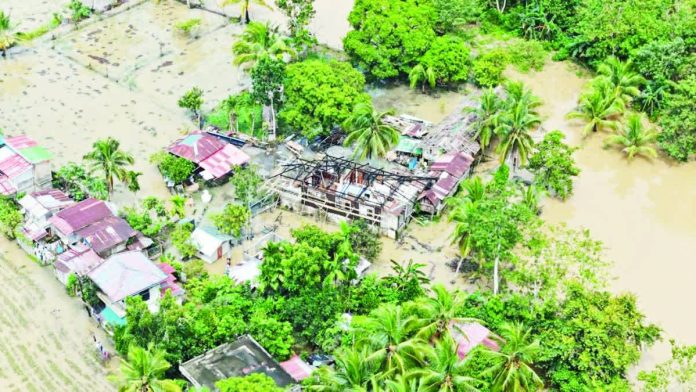 Capiz_flood_copy_resized_compressed AFTERMATH OF ‘RAMIL’ IN CAPIZ. An aerial view shows damaged homes and submerged farmlands along the highway leading to Sigma, Capiz, following the devastation brought by Tropical Storm “Ramil.” CIVIL DEFENSE WV PHOTO