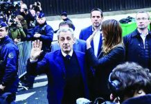 French ex-president starts jail sentence for finance conspiracy Former French President Nicolas Sarkozy and his wife wave at crowds and photographers on the street before he goes to prison. EPA