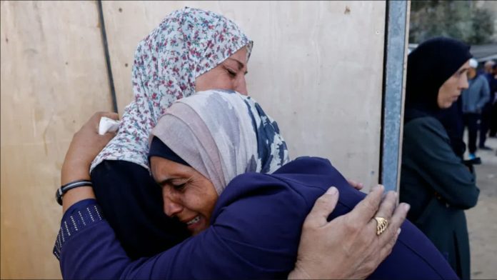 Gaza_compressed Women hug each other during the funeral of Palestinians killed in Israeli strikes, at al-Awda Hospital, in central Gaza. REUTERS