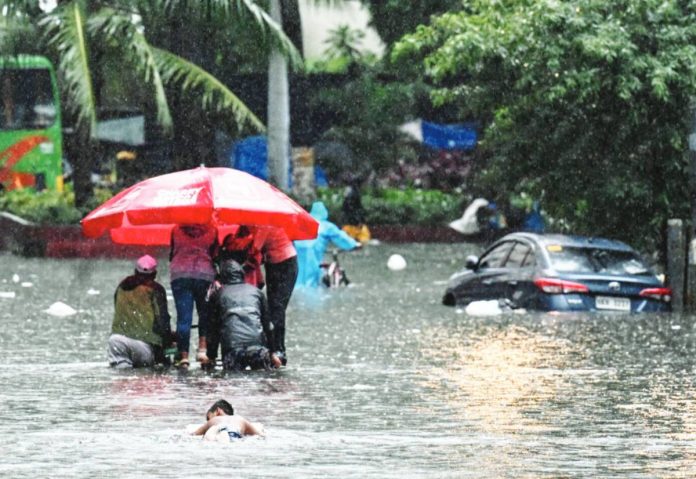 Green solution People wade through a flooded street in Manila on July 22, 2025, after heavy rains caused flooding enhanced by the monsoon. PHOTO BY JAM STA ROSA/AGENCE FRANCE-PRESSE