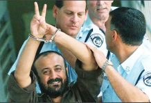 Hamas presses Israel to free prominent prisoners as part of Gaza truce deal Marwan Barghouti is hand cuffed and flashing the V-sign as he is led to a police vehicle by police officers wearing blue shirts. He was convicted of deadly attacks on Israeli civilians, but remains one of the most popular Palestinian leaders. AFP VIA GETTY IMAGES