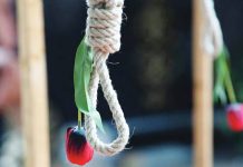 A rose hangs from a noose displayed during a protest by exiled Iranian opposition group, the National Council of Resistance of Iran, and other Franco-Iranian groups in Paris, France. GETTY IMAGES