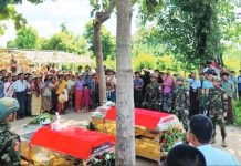Villagers and soldiers attend the funeral of victims killed in an airstrike in Myanmar’s Sagaing region on Oct. 8, a day after a military paraglider dropped bombs on a crowd celebrating the Thadingyut Buddhist festival. At least 24 people were confirmed dead and 47 wounded in what rights groups condemned as part of the junta’s escalating air campaign against civilians. PDF