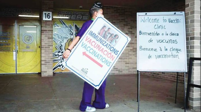 A woman holds an immunization sign in the United States. So far this year the US has confirmed 1,563 measles cases, the highest level nationwide in more than 30 years, according to the Centers for Disease Control and Prevention. GETTY IMAGES