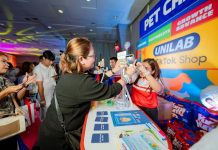 An affiliate enjoys participating in the activity, one of the many brand booths showcased for the event.