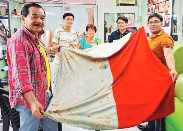 A LIVING RELIC OF HISTORY. This 127-year-old Philippine flag, believed to have been brought by General Emilio Aguinaldo from Hong Kong and hoisted in Libertad, Antique during the 1898 revolution, is is set to be turned over to the provincial government of Antique. PHOTO COURTESY OF ERROL SANTILLAN 