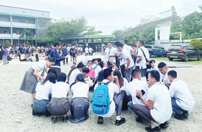 doublet Students at the Davao de Oro State College gathered in an open area after the recent strong earthquake that was felt across Mindanao and Western Visayas. AFP