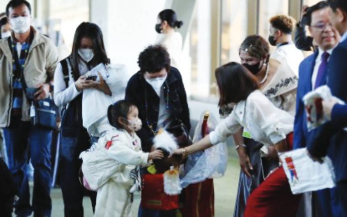 A young Chinese tourist is welcomed by Department of Tourism Secretary Christina Frasco at Ninoy Aquino International Airport Terminal 3 in Pasay City in this 2023 file photo. An increase in Chinese arrivals is expected in the next six months once the eVisa program for China is implemented in November. PNA FILE PHOTO