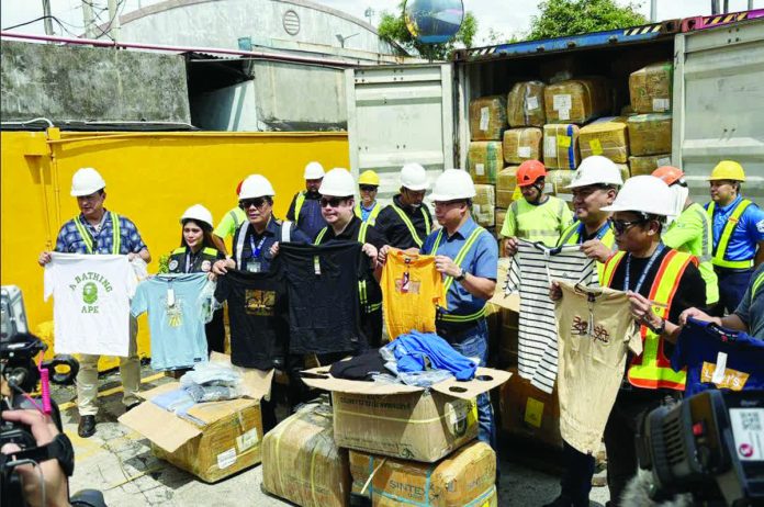 fake_clothes_copy_resized_compressed Officials of the Bureau of Customs present millions of pesos worth of counterfeit clothes. The clothes were tagged as branded and supposedly to be sold this holiday season. JEKKI PASCUAL/ABS-CBN NEWS PHOTO
