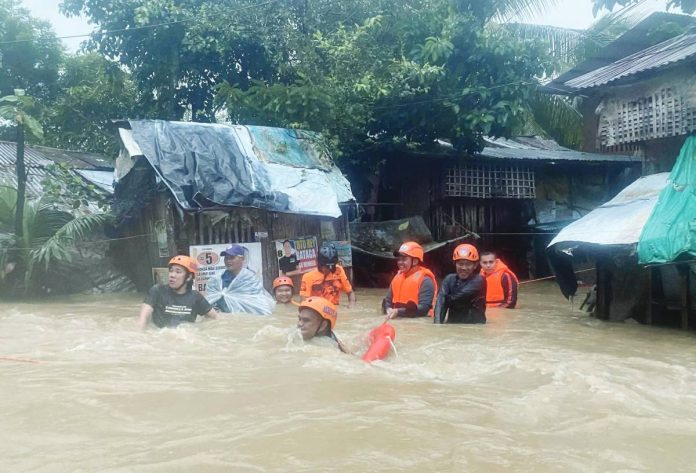 flood pic1 Estancia Fire Station personnel rescue stranded residents due to flooding, on Oct. 18, 2025. Data from the Provincial Disaster Risk Reduction and Management Office showed that low-lying villages in Estancia, Balasan, and Carles towns were the hardest hit. ESTANCIA FIRE STATION PHOTO