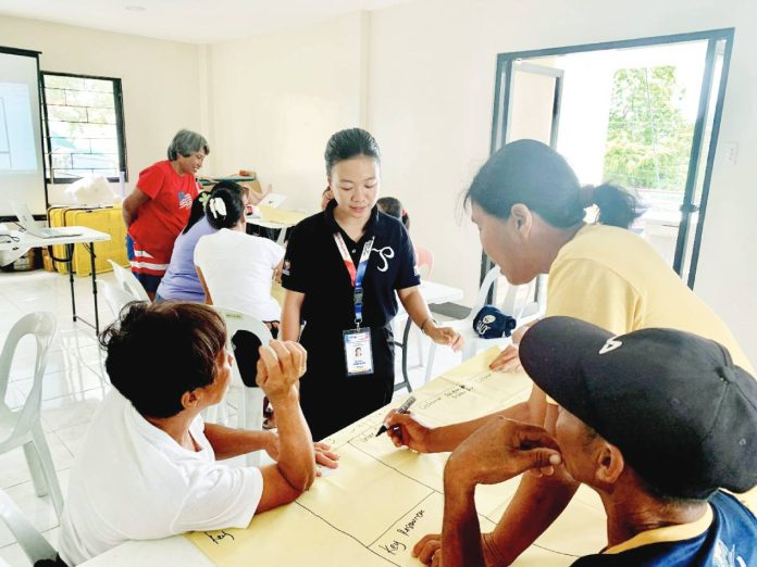 Ghea Rodriguez, business counselor, guides the M. Chavez Salt Producers Association members during the hands-on activity on preparing their Business Model Canvas. DTI-GUIMARAS PHOTO