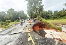Sigma, Capiz’s Mayor Dante Eslabon, along with local public works officials, inspects the flood-damaged road in Barangay Ibia-an, Mianay, Sigma, where a large sinkhole has rendered the area impassable to vehicles. PHOTO FROM THE MUNICIPALITY OF SIGMA