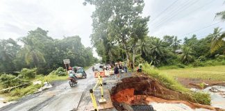 Sigma, Capiz’s Mayor Dante Eslabon, along with local public works officials, inspects the flood-damaged road in Barangay Ibia-an, Mianay, Sigma, where a large sinkhole has rendered the area impassable to vehicles. PHOTO FROM THE MUNICIPALITY OF SIGMA