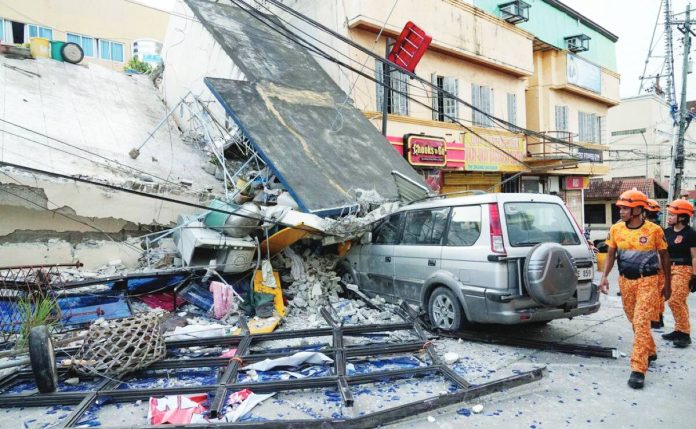 neljoy cebu aid Firemen walk beside a collapsed building caused by a recent strong earthquake in Bogo Cty, Cebu Province. The Iloilo Provincial Government is extending financial assistance to earthquake victims in Cebu. AP PHOTO/AARON FAVILA
