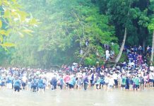 Thousands of volunteers wade across a stream leading to the Maasin Watershed to take part in the massive tree planting activity that marked the 25th Piyesta sa Kakahuyan. Around 1,600 participants from various sectors helped plant 5,000 native and endangered seedlings. PHOTO COURTESY OF BALITA HALIN SA KAPITOLYO