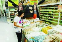 A Department of Trade and Industry - Region 6 personnel inspects candle prices in a supermarket in Iloilo City as part of intensified monitoring ahead of the All Saints Day and All Souls Day observance. The agency confirmed that prices of candles and bottled water across Western Visayas remain stable with no signs of overpricing or supply shortage. DTI-6 PHOTO