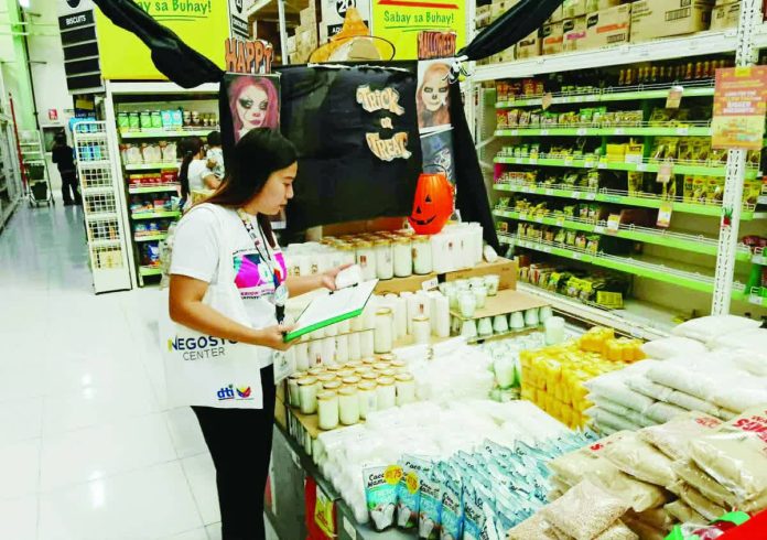 neljoy_steady_prices_resized_compressed A Department of Trade and Industry - Region 6 personnel inspects candle prices in a supermarket in Iloilo City as part of intensified monitoring ahead of the All Saints Day and All Souls Day observance. The agency confirmed that prices of candles and bottled water across Western Visayas remain stable with no signs of overpricing or supply shortage. DTI-6 PHOTO