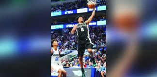 San Antonio Spurs guard Dylan Harper (2) scores against Dallas Mavericks guard Max Christie (00). PHOTO BY LM OTERO/AP