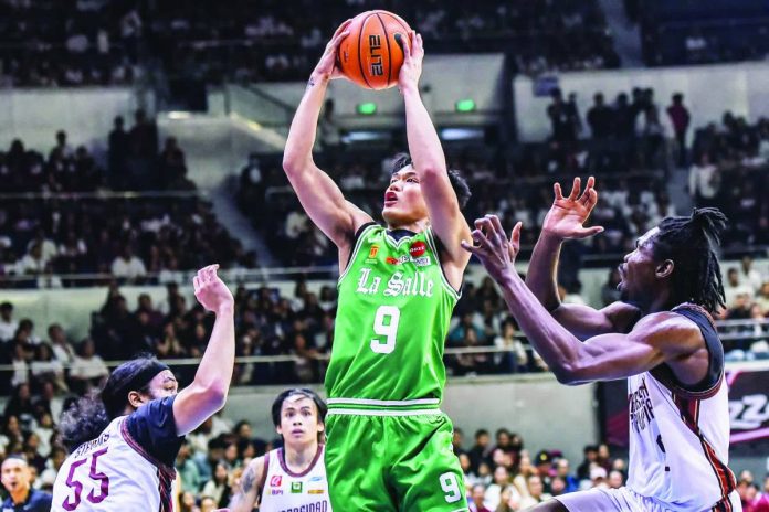 sports Pablo_compressed De La Salle University’s Manuel Luis Pablo soars for a basket against University of the Philippines’ defense. UAAP PHOTO