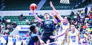 Meralco Bolts’ CJ Cansino powers his way to the basket against Magnolia’s Javier Gomez de Liaño. PBA PHOTO