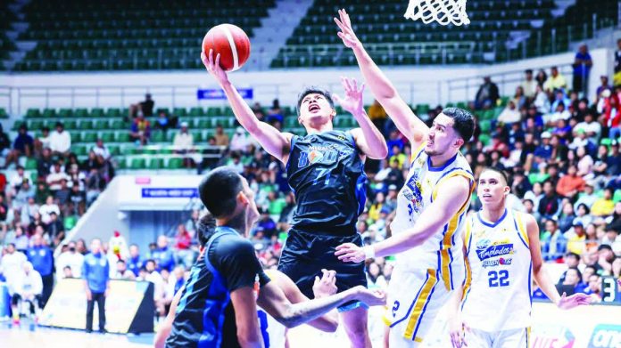 Meralco Bolts’ CJ Cansino powers his way to the basket against Magnolia’s Javier Gomez de Liaño. PBA PHOTO