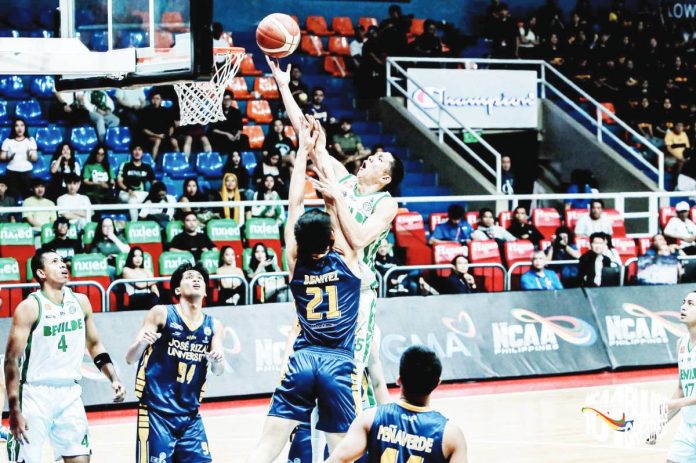 Negrense Raffy Celis of College of St. Benilde Blazers goes for an inside hit against the Jose Rizal University Heavy Bombers’ defense. Photo by NCAA/GMA Sports