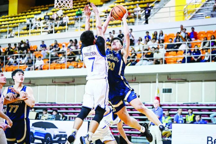 sports_Figueroa_resized_compressed National University’s Jake Figueroa powers his way to the basket against Ilonggo Ian Espinosa of Ateneo de Manila University during their UAAP Season 88 clash at the UST Quadricentennial Pavilion. UAAP PHOTO