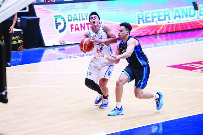 sports_Nambatac_resized_compressed TNT Tropang 5G’s Rey Nambatac rises for the game-winning jumper against Meralco Bolts’ Chris Banchero during their PBA Philippine Cup clash at the Ynares Center. PBA PHOTO